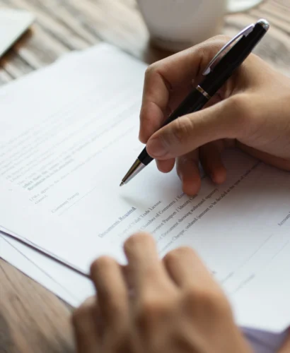 businessman-examining-papers-table