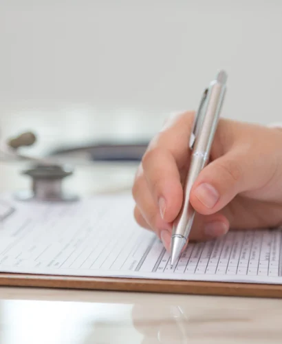 doctor-filling-out-medical-form