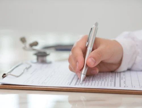 doctor-filling-out-medical-form