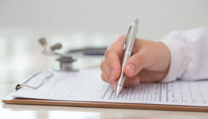 doctor-filling-out-medical-form