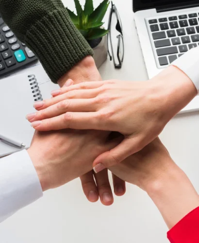 top-view-hands-together-work-desk