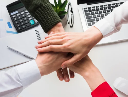 top-view-hands-together-work-desk
