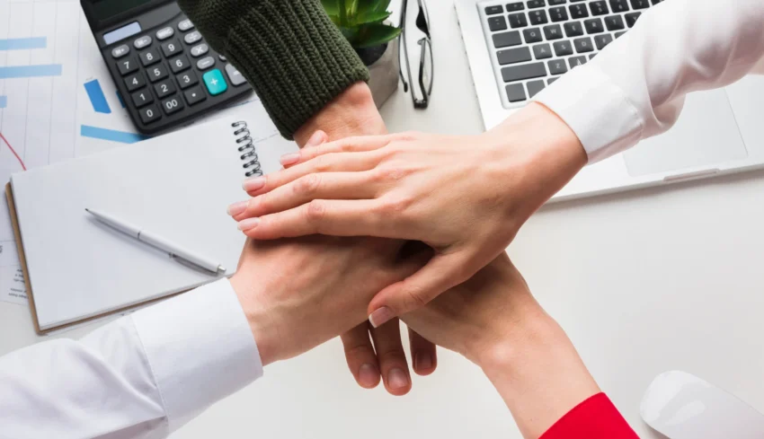 top-view-hands-together-work-desk